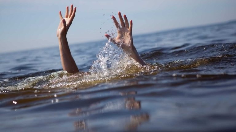 man jumping into the river